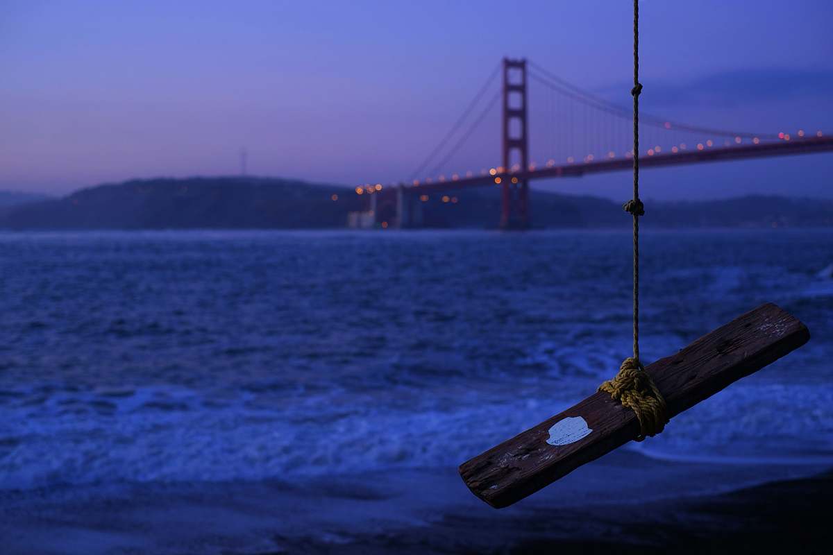blue brown wood plank tied by rope hangs near tree overview bridge united states